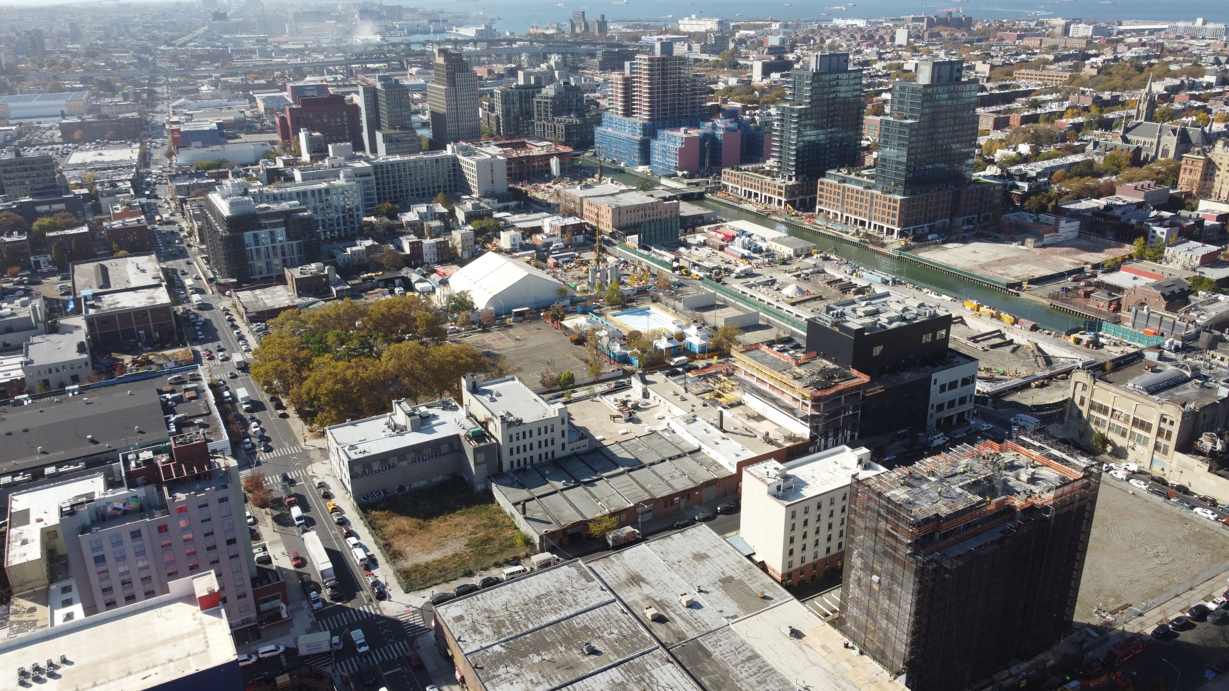 Street-level aerial shot of Gowanus construction sites with new retail storefronts, maker space, and commercial buildings emerging.