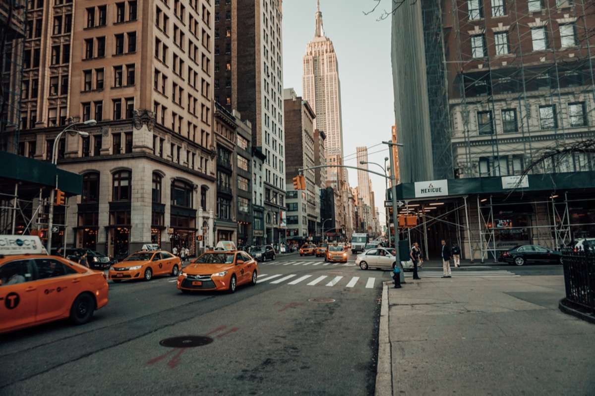 Yellow Cab in a street of New York City with the Empire sate building