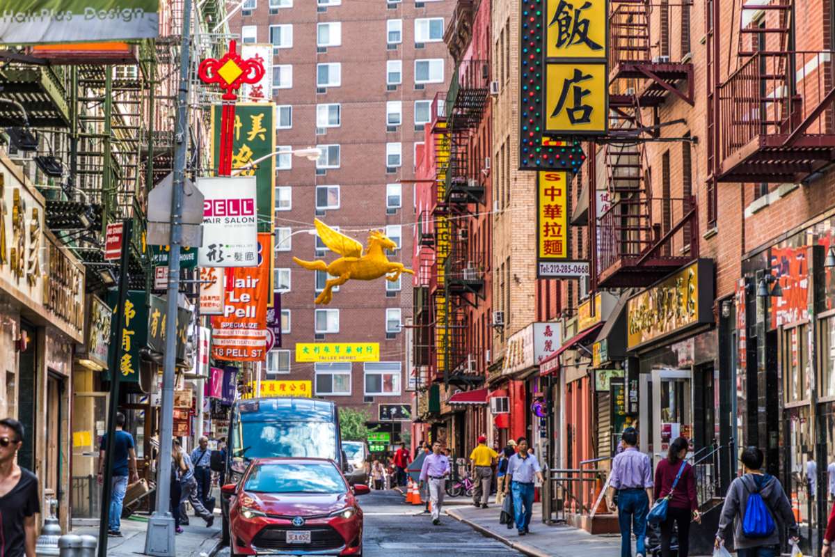 chinatown with shops with chinese letters and pegasus in Chinatown, New York.